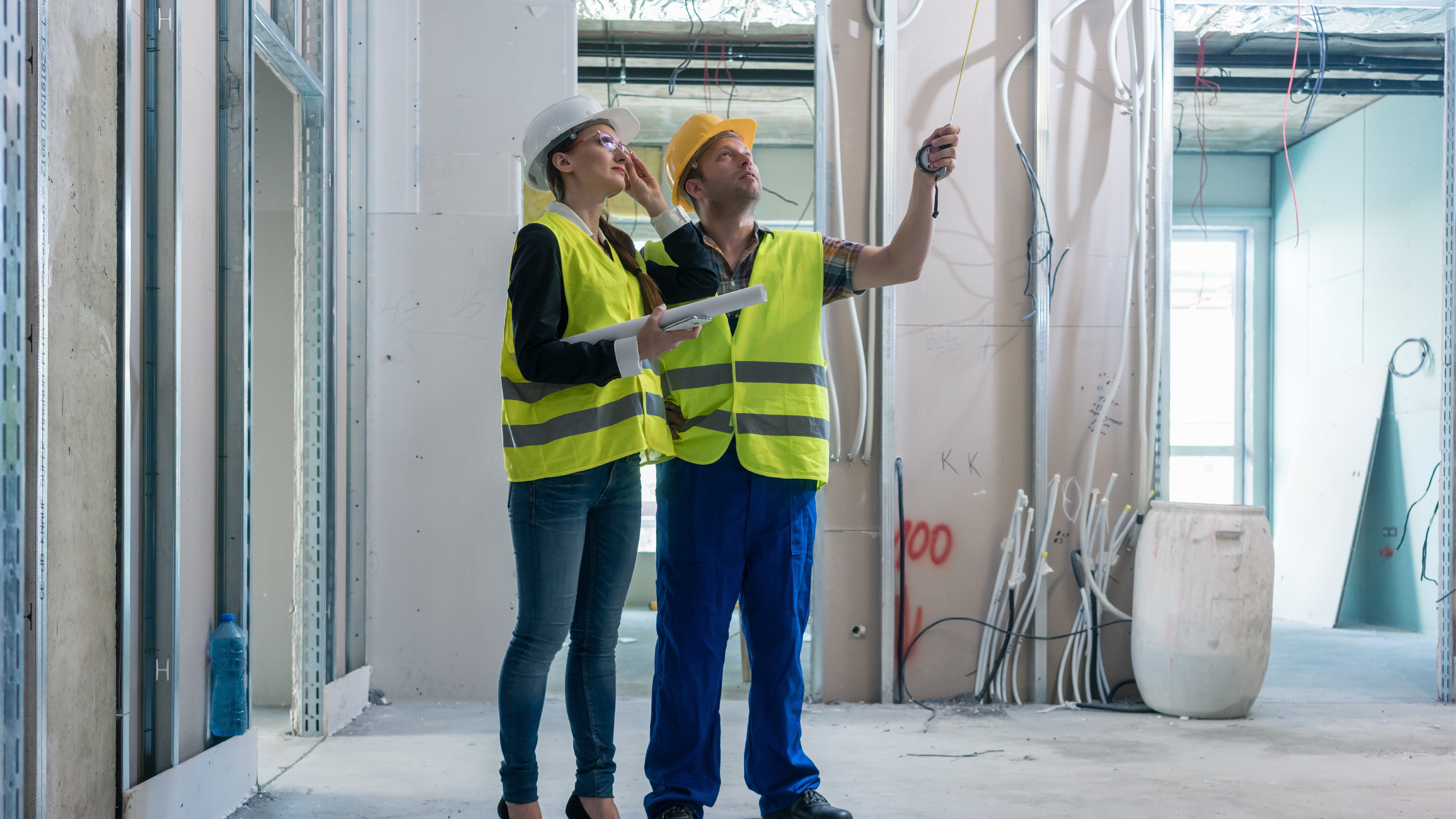 a person and person in safety vests and hardhats