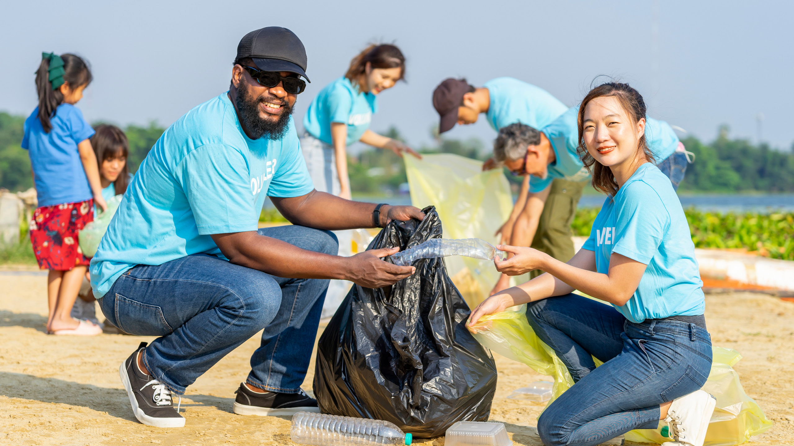 a group of people picking up trash