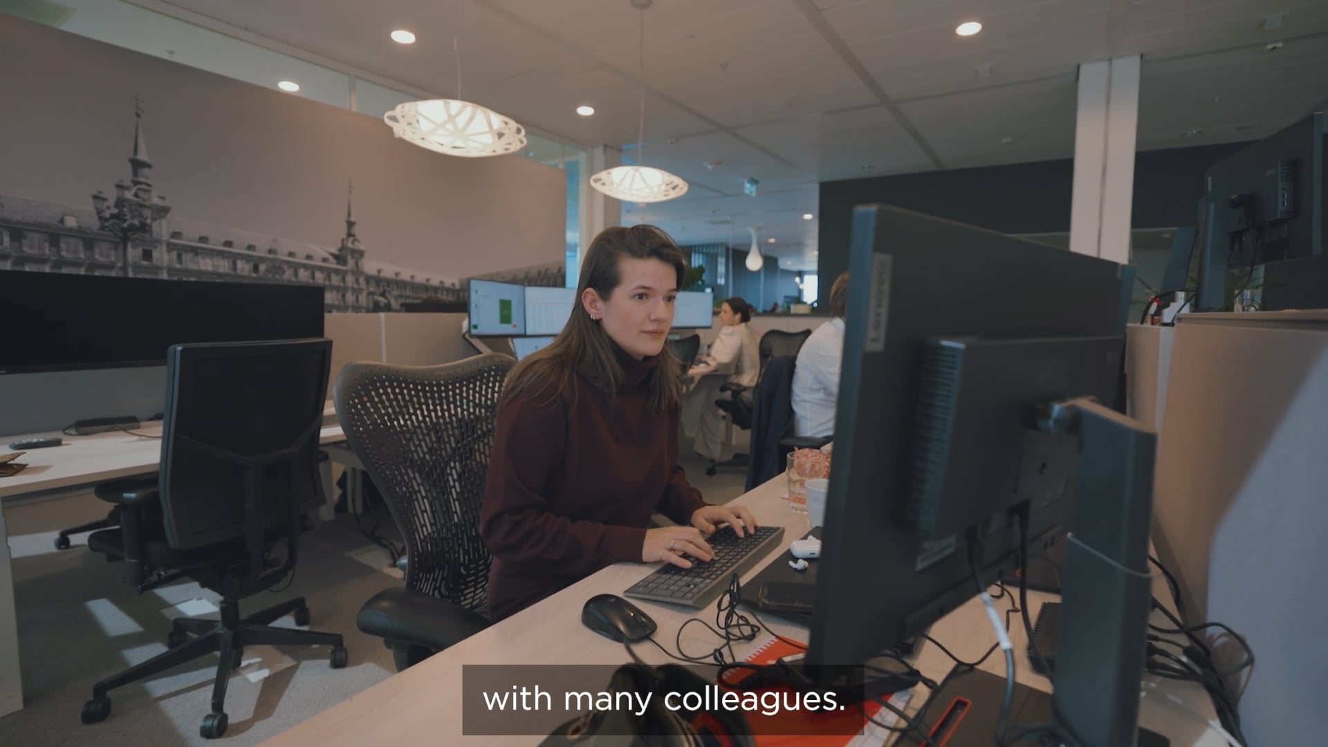 a person sitting at a desk with a computer