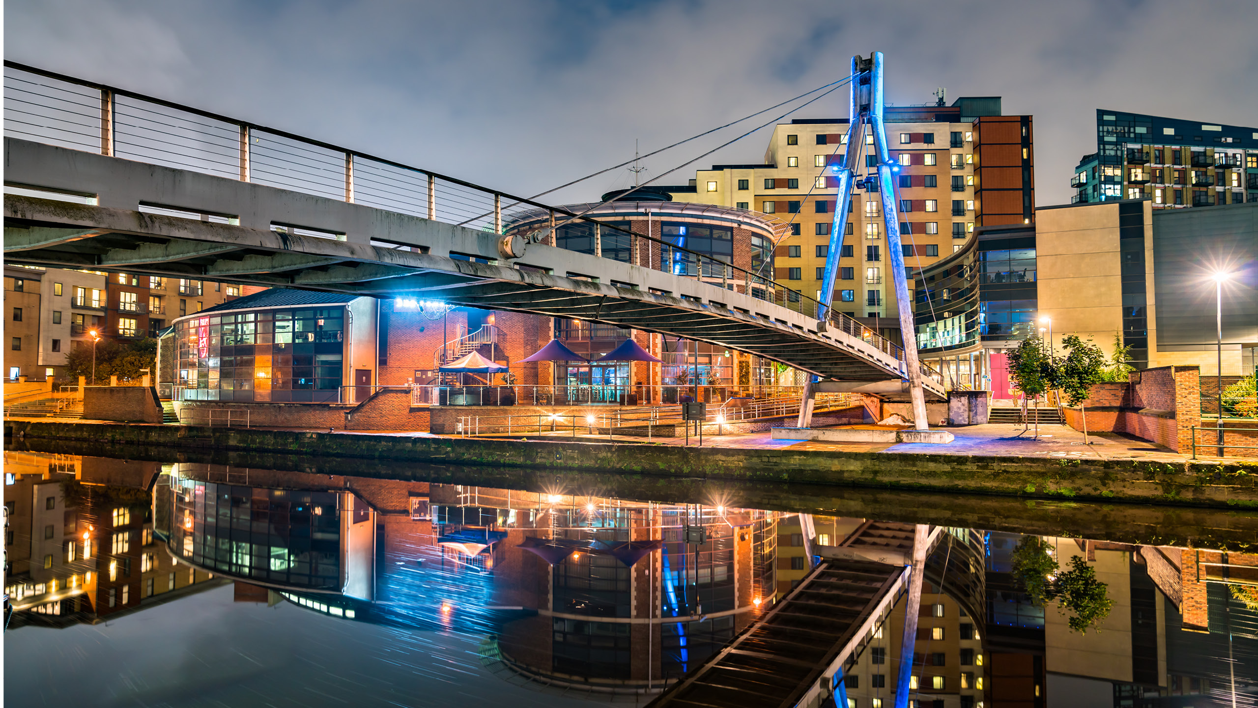 a bridge over water with buildings and a bridge