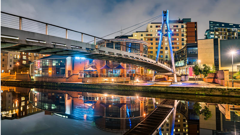 a bridge over water with buildings and a bridge