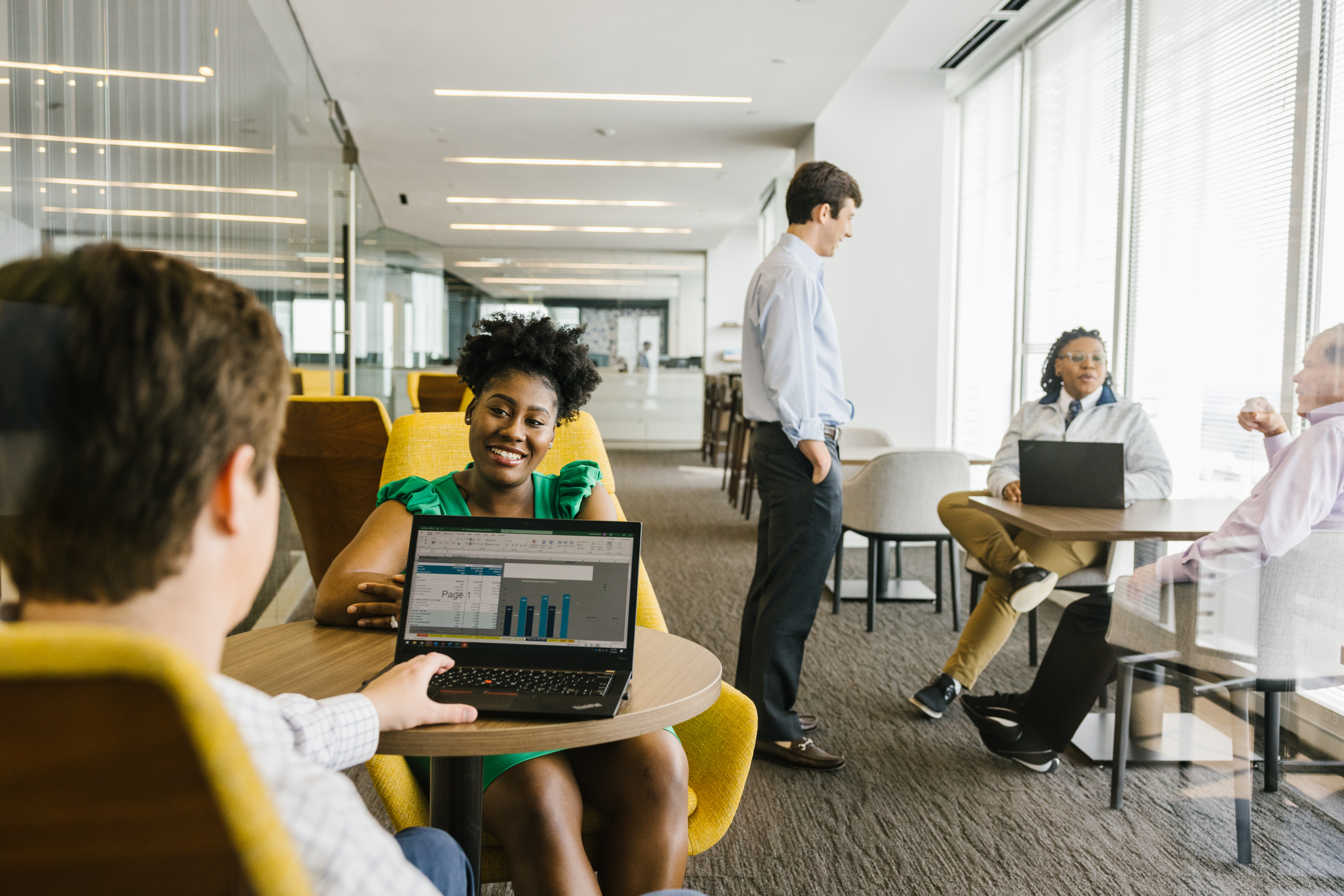 a person sitting at a table with a laptop