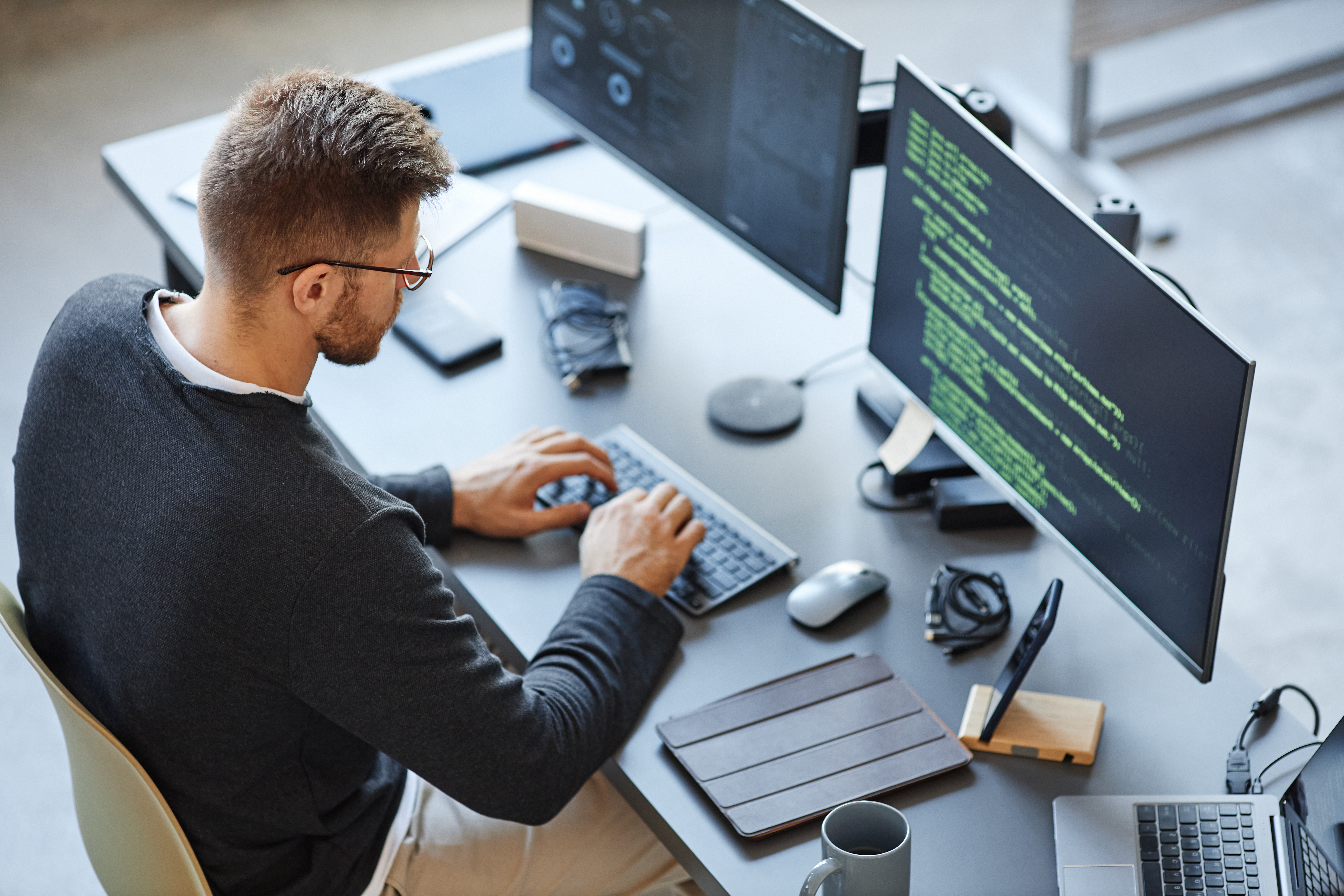 a person sitting at a desk using a computer