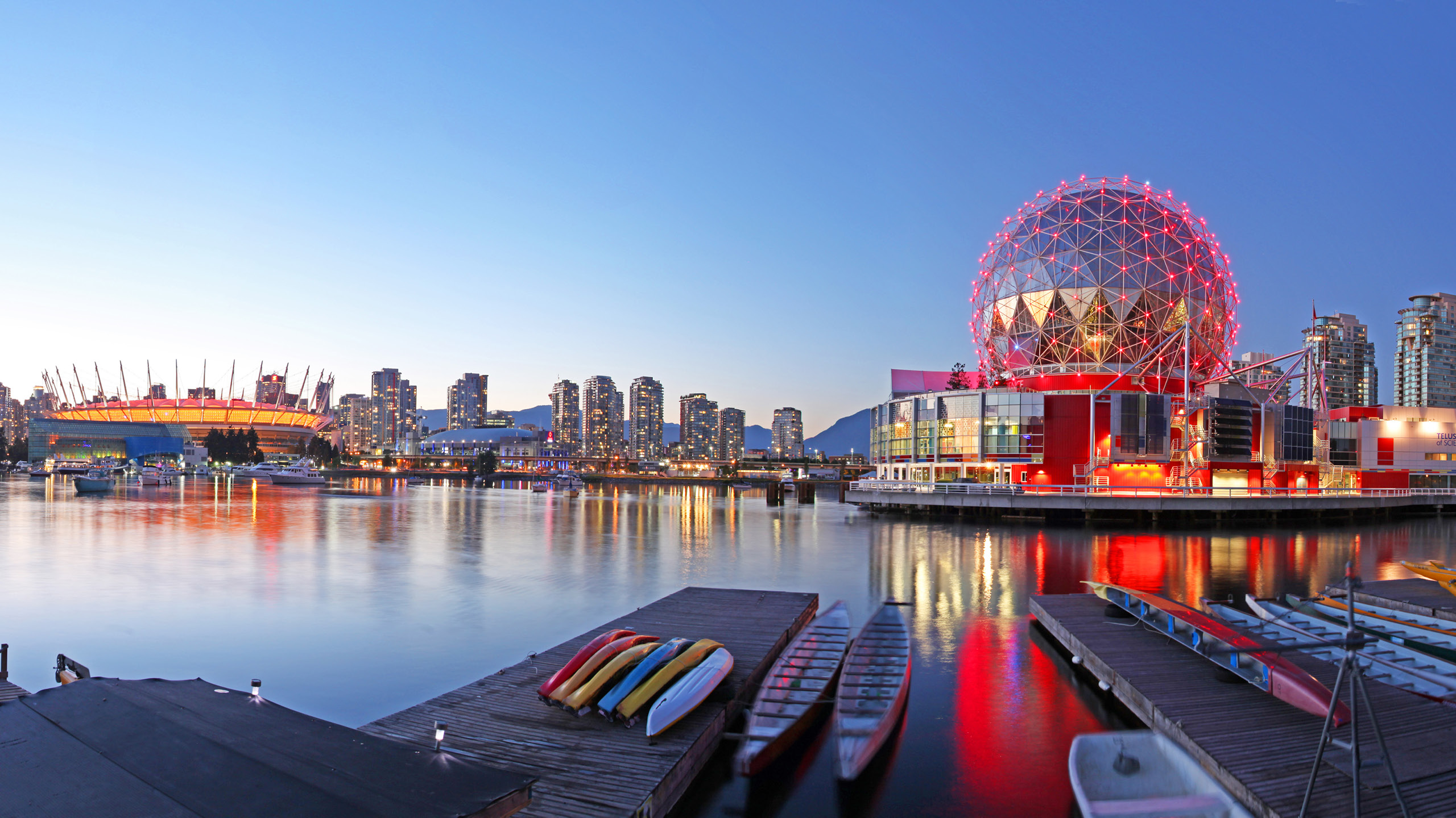 boats on a dock next to Science World