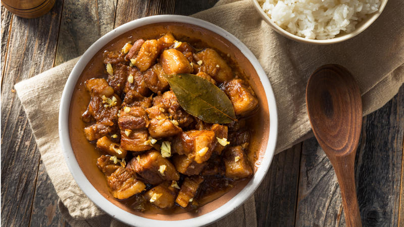 a bowl of food with a bowl of rice and a spoon