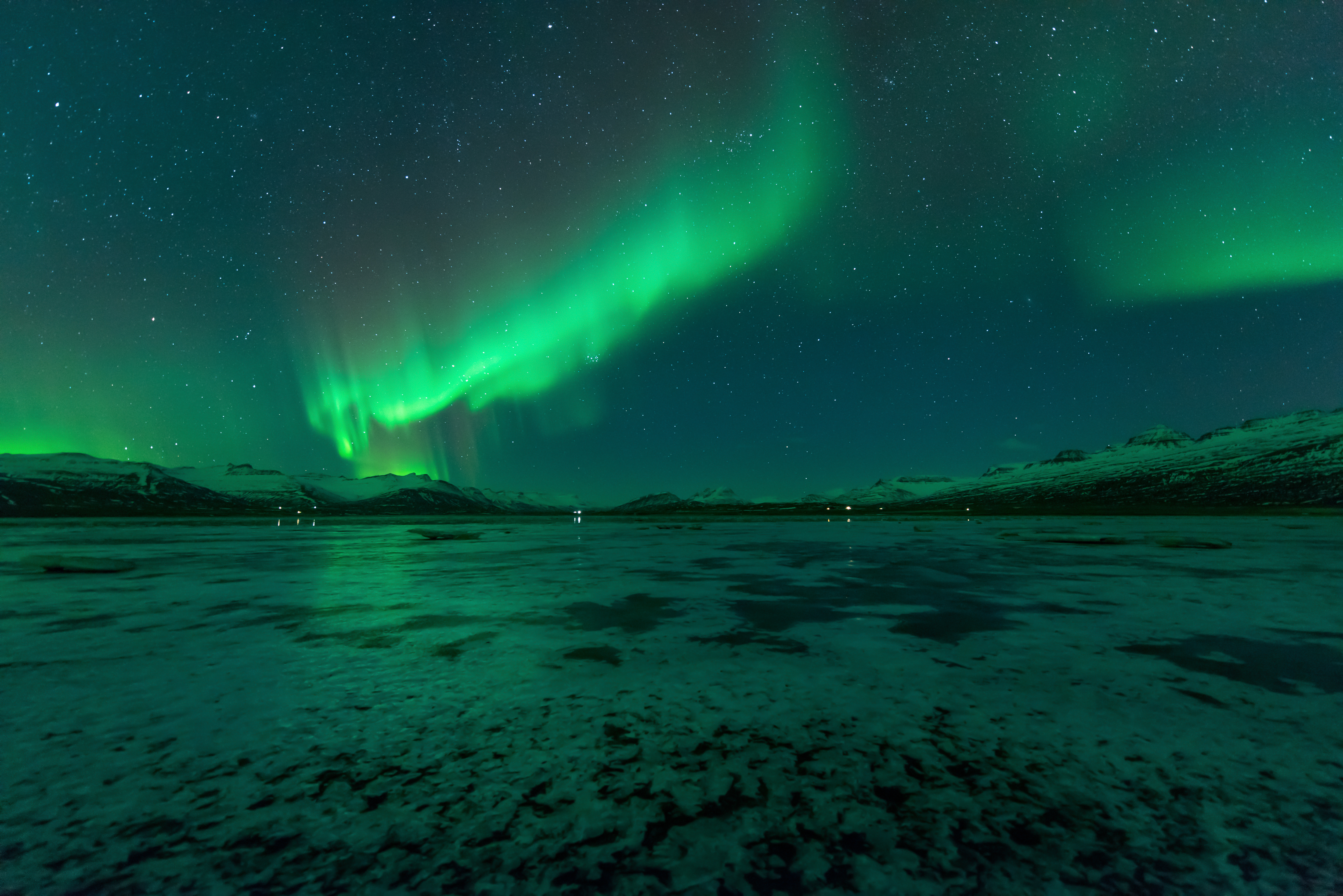 a green lights in the sky over a lake