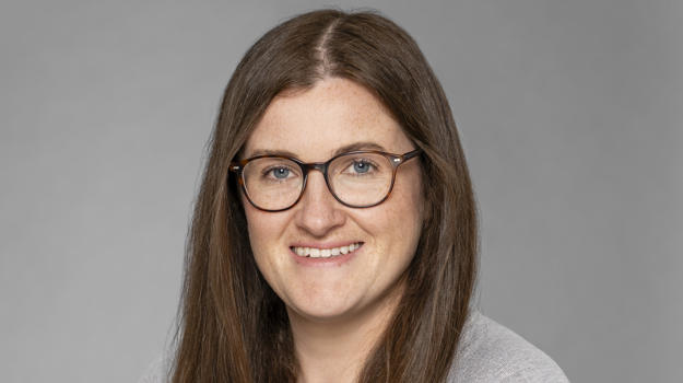 a person with long brown hair wearing glasses