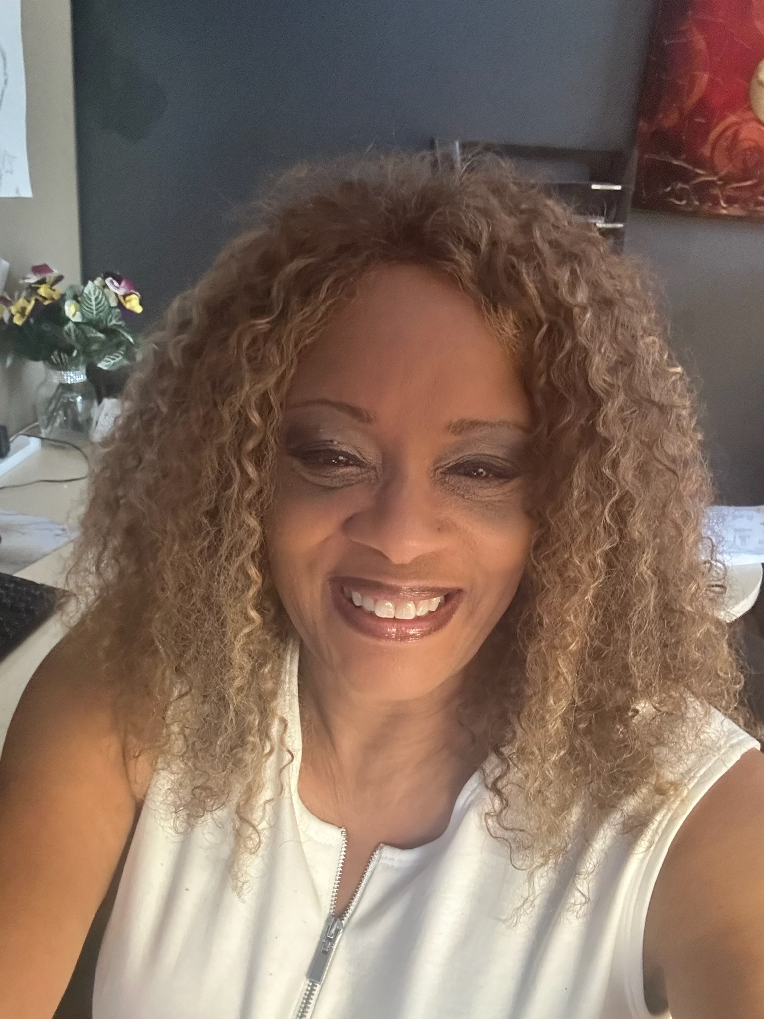 a person with curly hair smiling