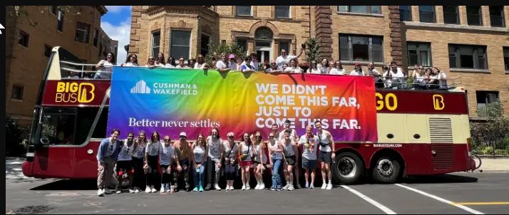 a group of people standing in front of a large banner