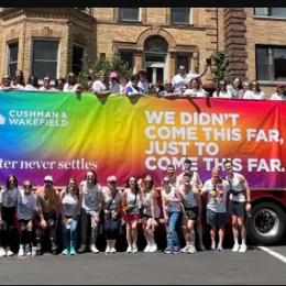 a group of people standing in front of a large banner