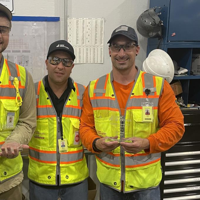 a group of men wearing safety vests and hats