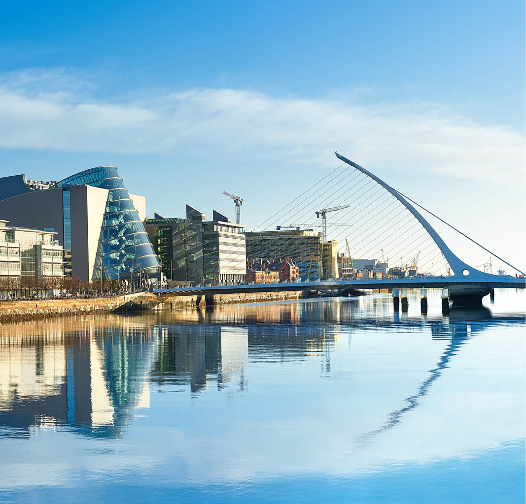 a bridge over water with buildings in the background