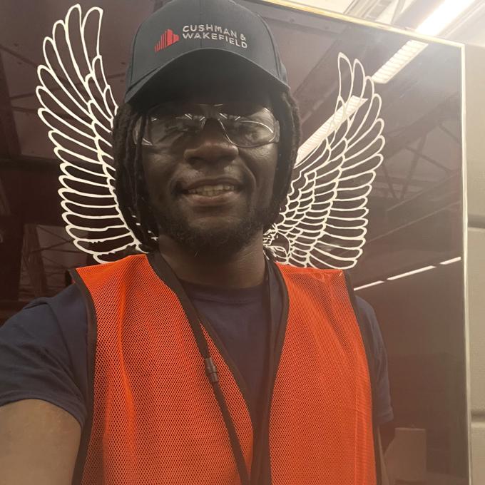 a person wearing a hat and orange vest