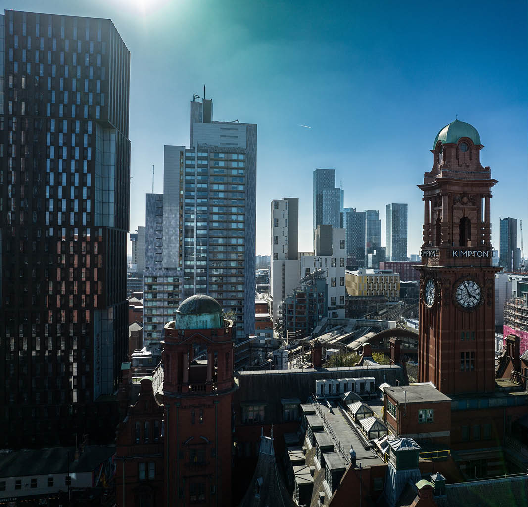 a city with tall buildings and a clock tower