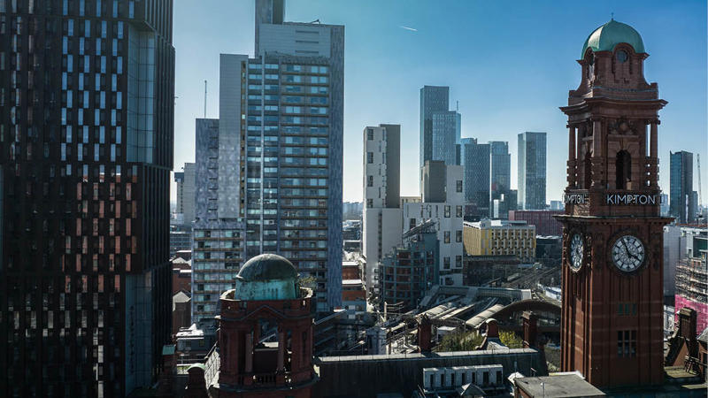 a city with tall buildings and a clock tower