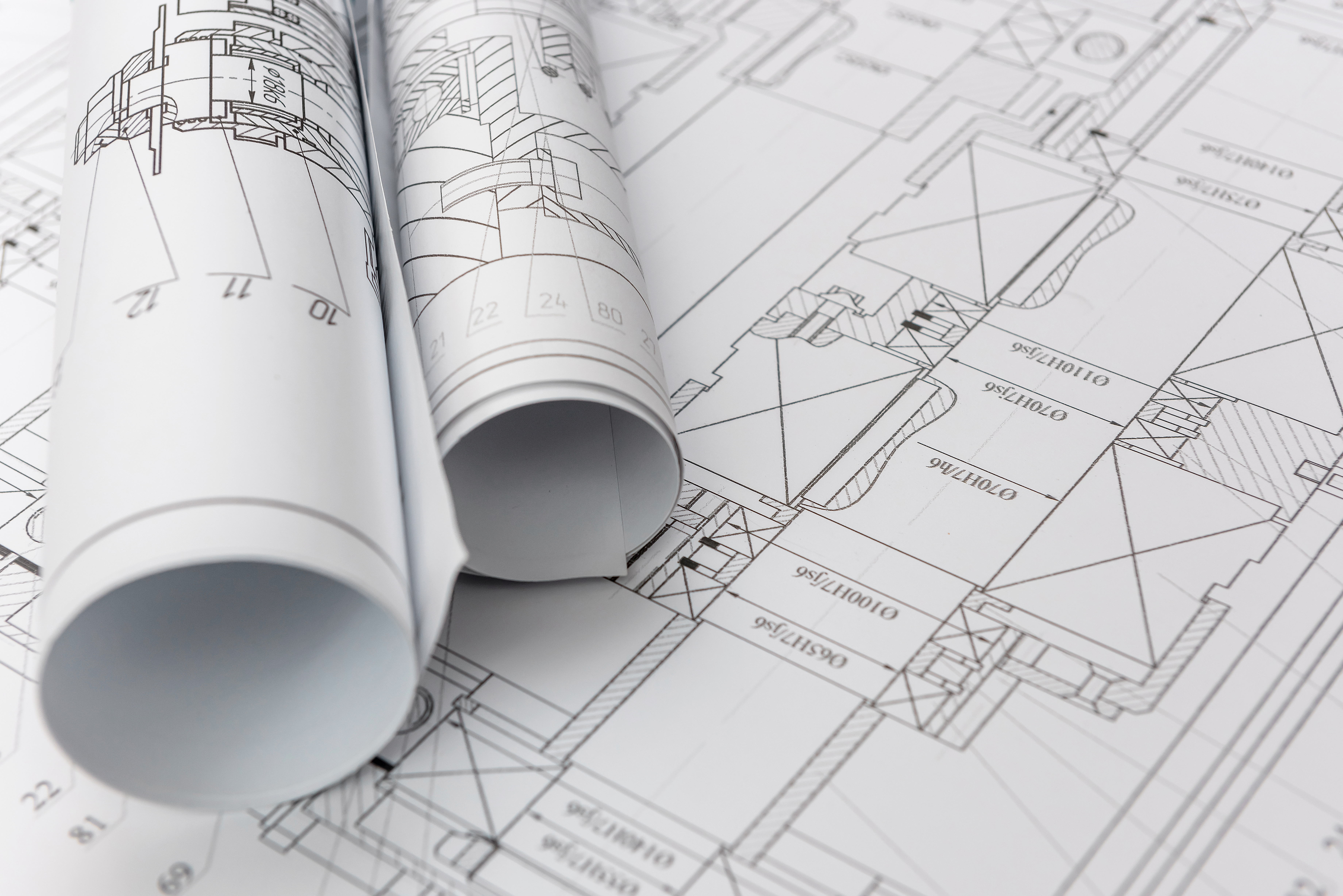a rolled up blueprints on a table