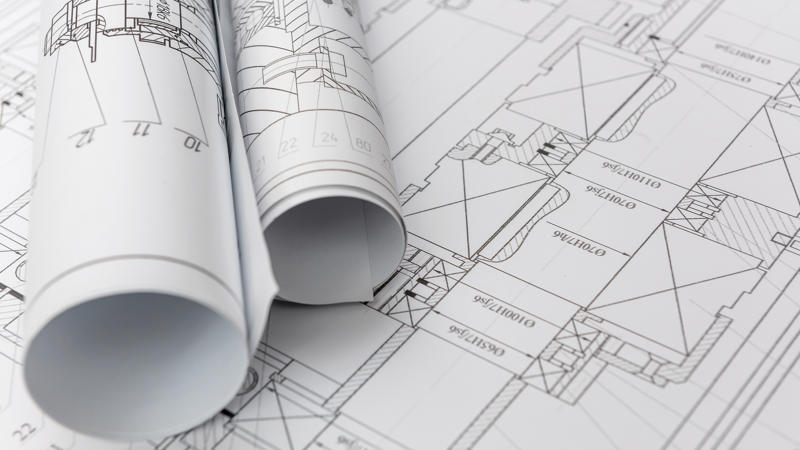a rolled up blueprints on a table