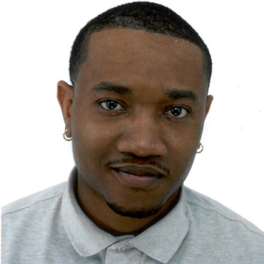 a person with short hair wearing earrings