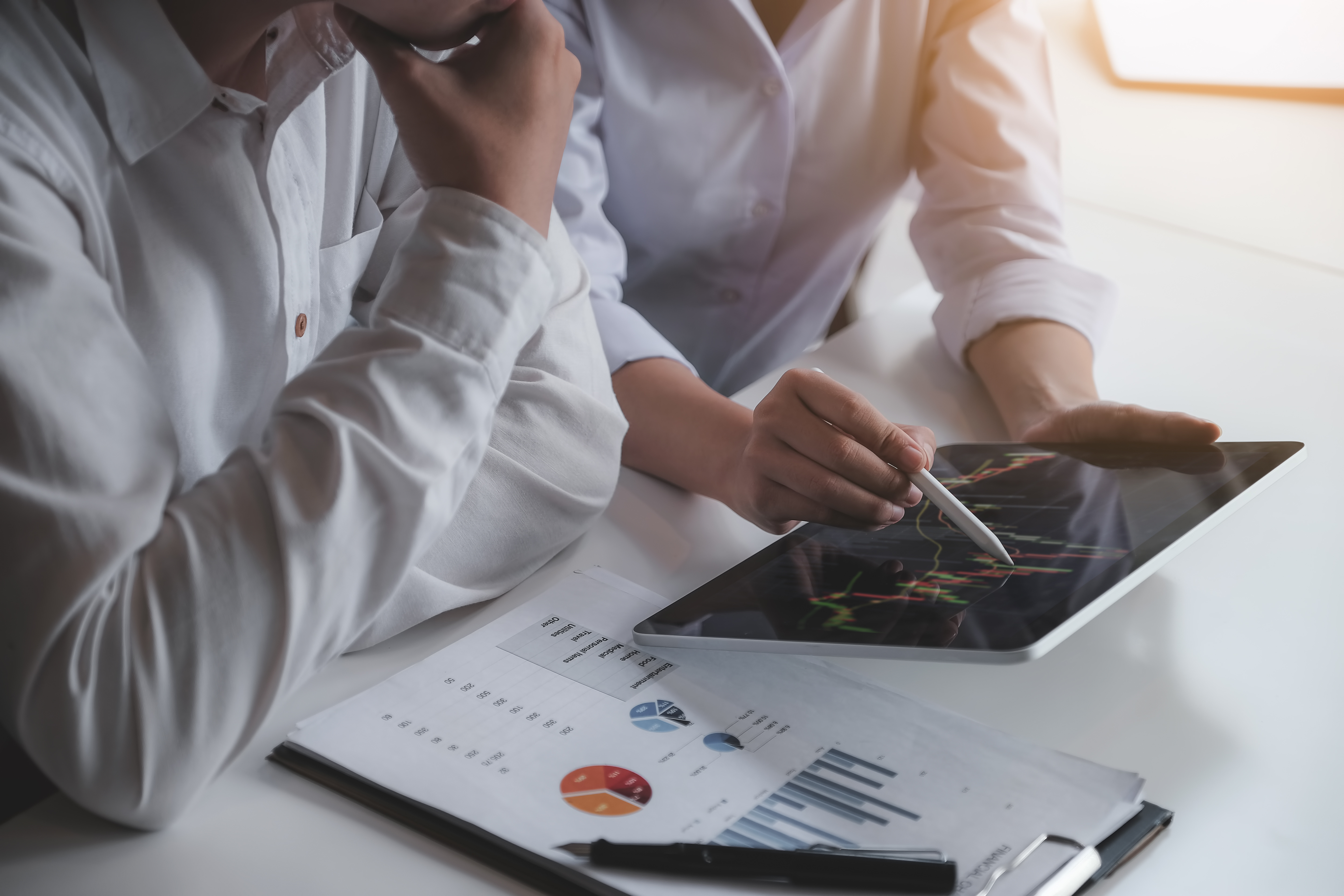 a person and person looking at a tablet