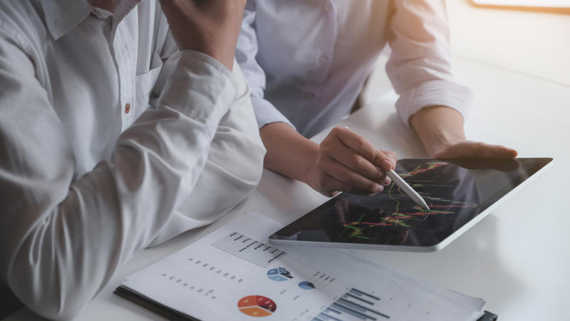 a person and person looking at a tablet