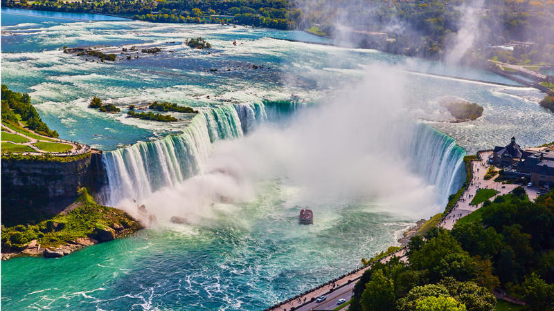 a large waterfall with a boat in it