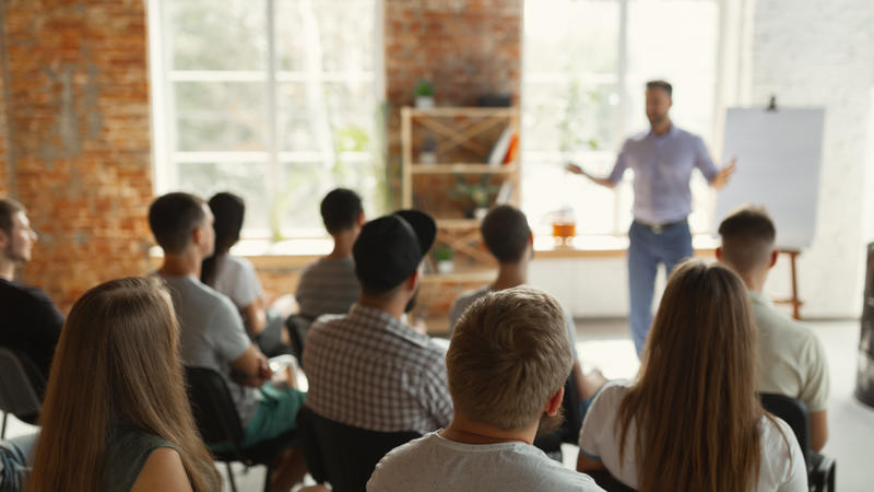 a person standing in front of a group of people