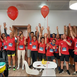 a group of people in matching red shirts with numbers and numbers