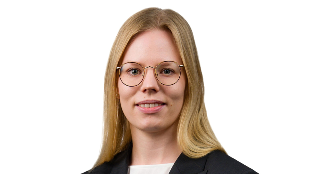 a person wearing glasses and a suit