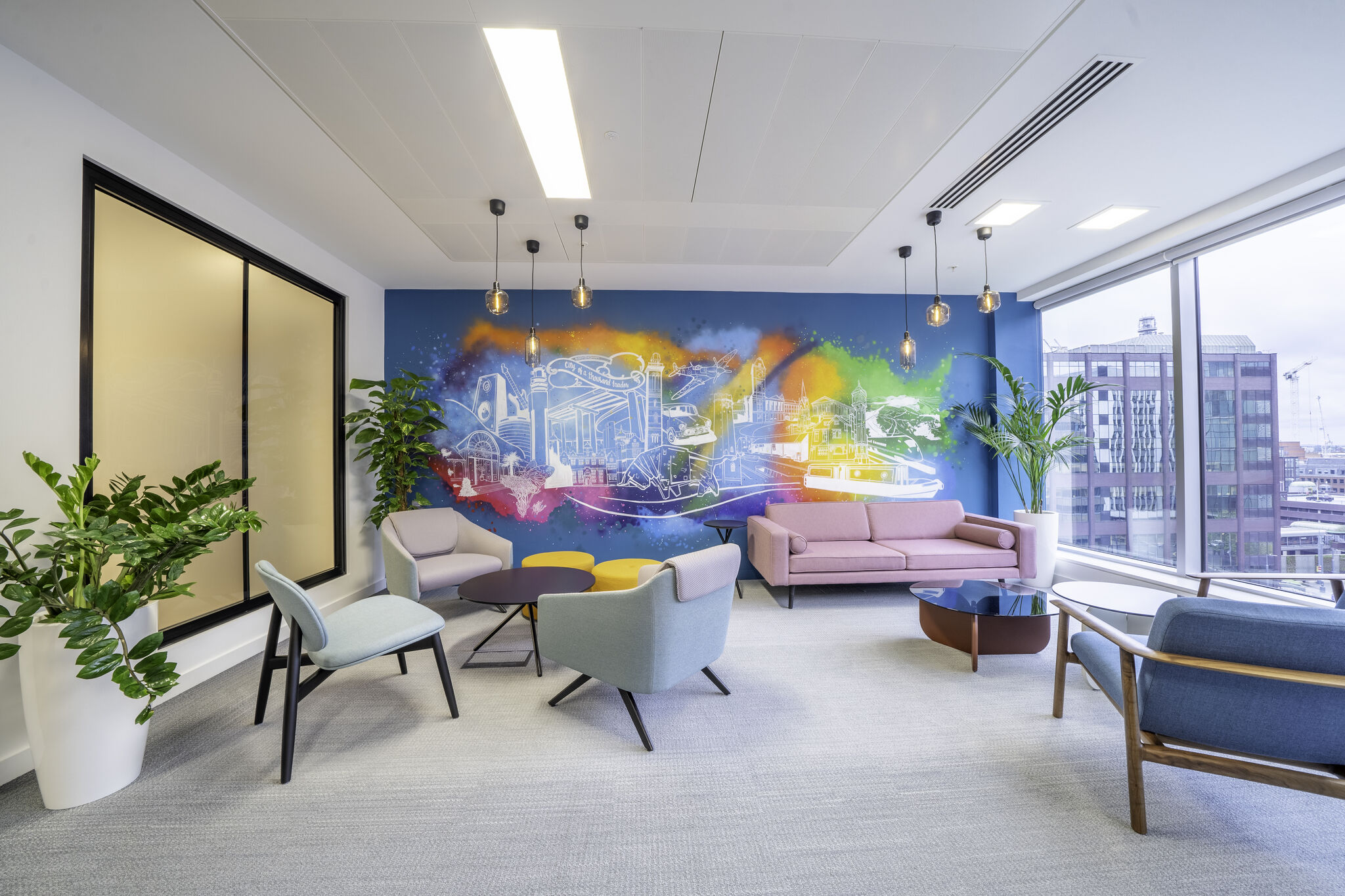 a room with a colorful wall mural and chairs