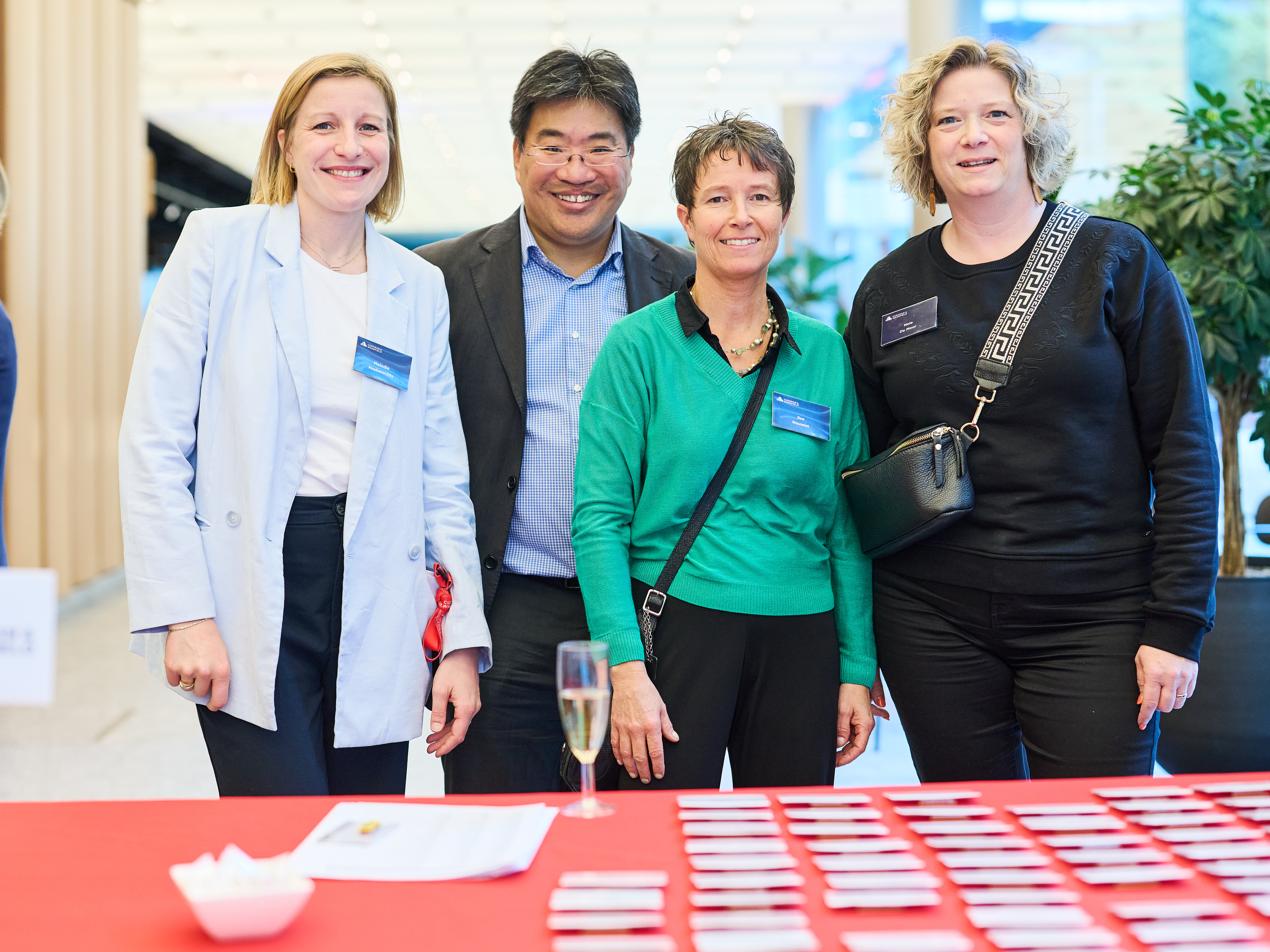 a group of people standing in front of a table with cards
