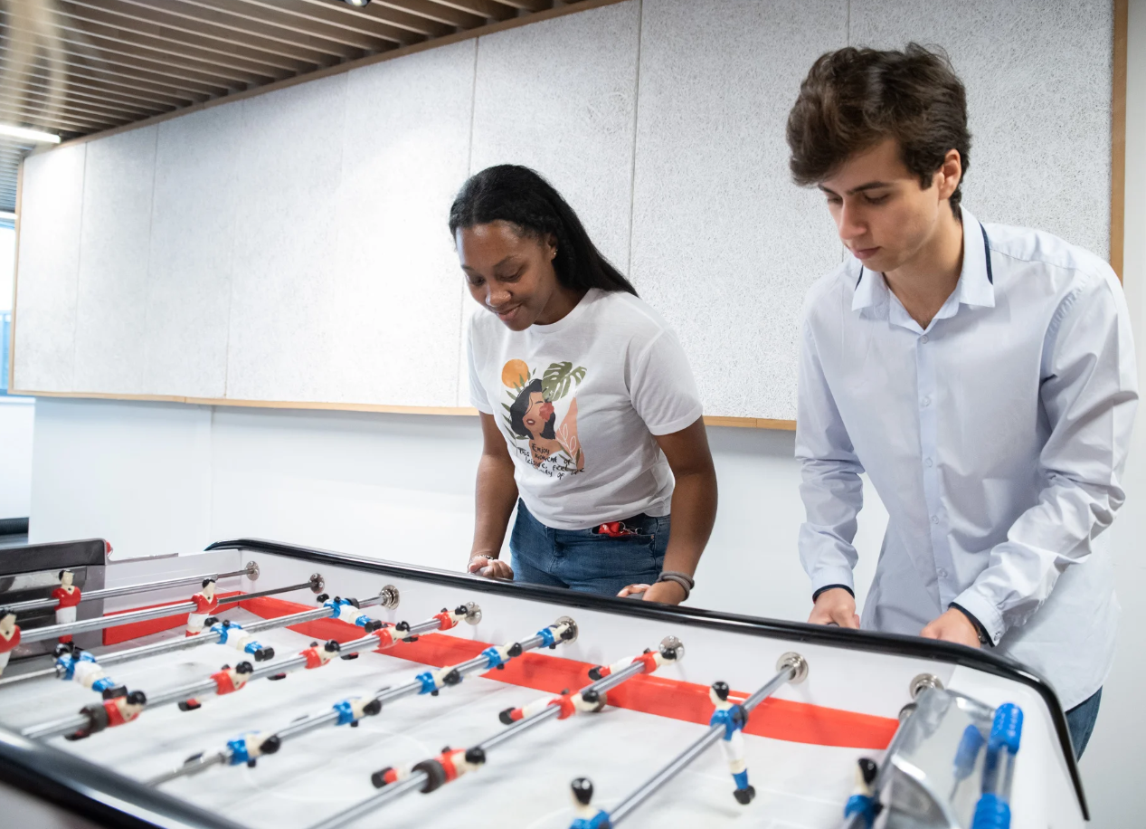 a person and person playing foosball