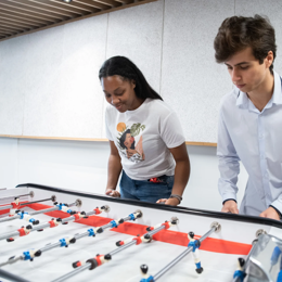 a person and person playing foosball